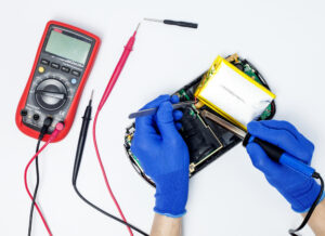 hands repairing a handheld video game console system, nintendo switch repair