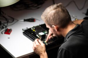 man repairing a playstation console